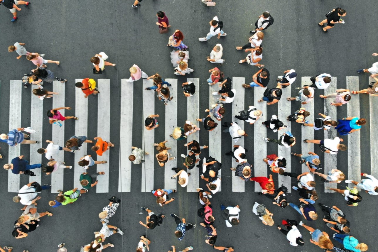 People crowd on pedestrian crosswalk